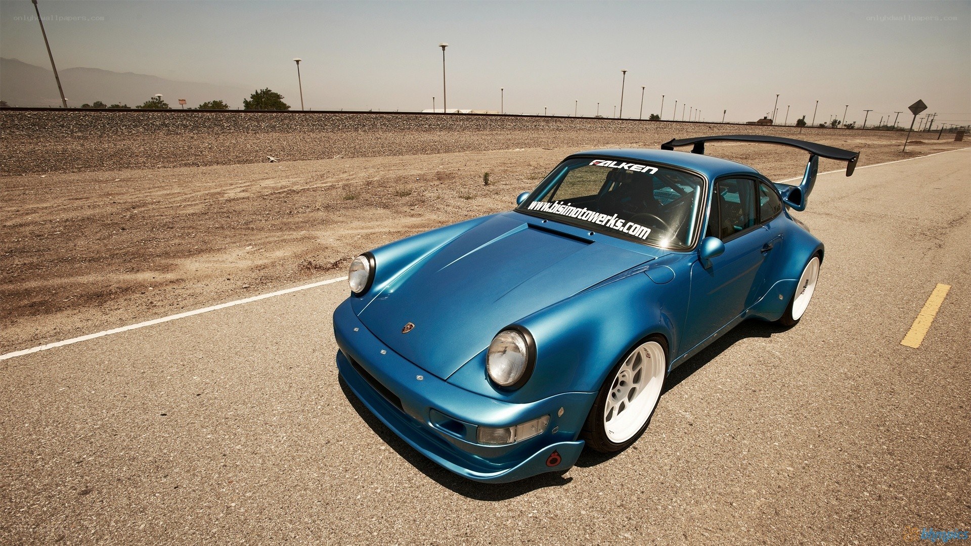 blue porsche on a road