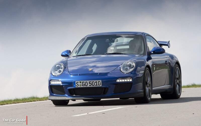 blue porsche on a road
