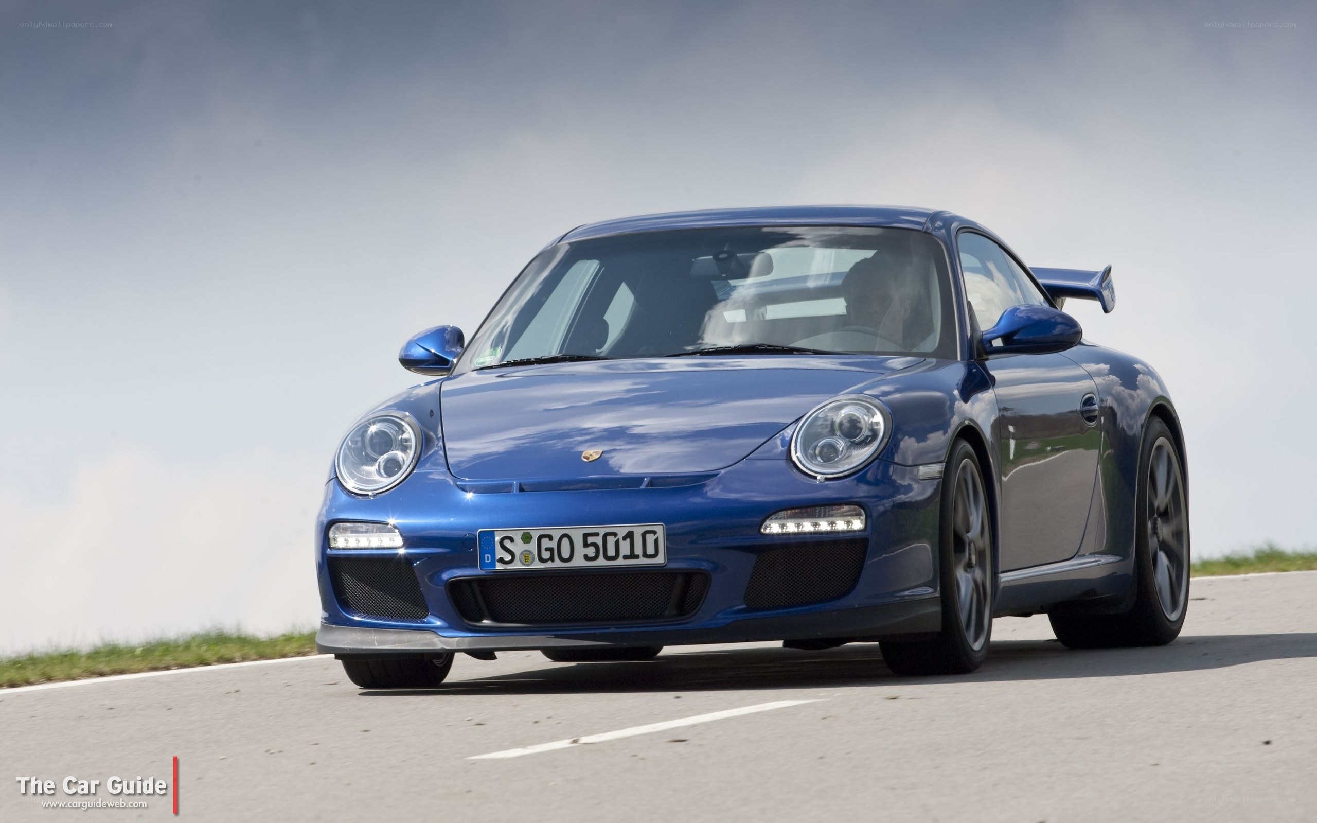 blue porsche on a road