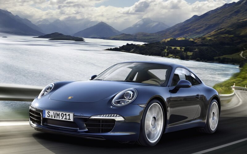 Blue Porsche on a scenic road