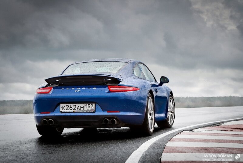 Blue Porsche on a wet track