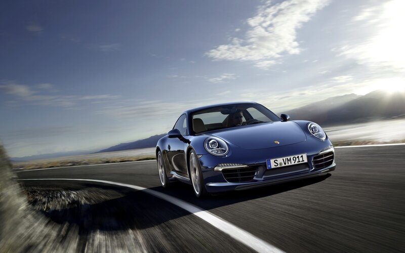 Blue Porsche on a winding road