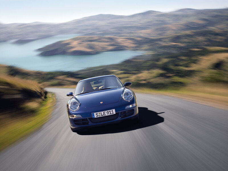 Blue Porsche on a winding road