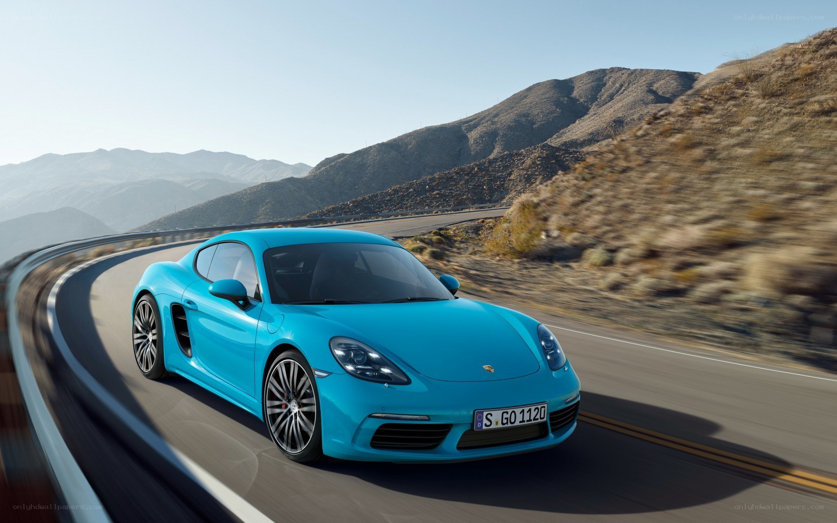 Blue Porsche on mountain road
