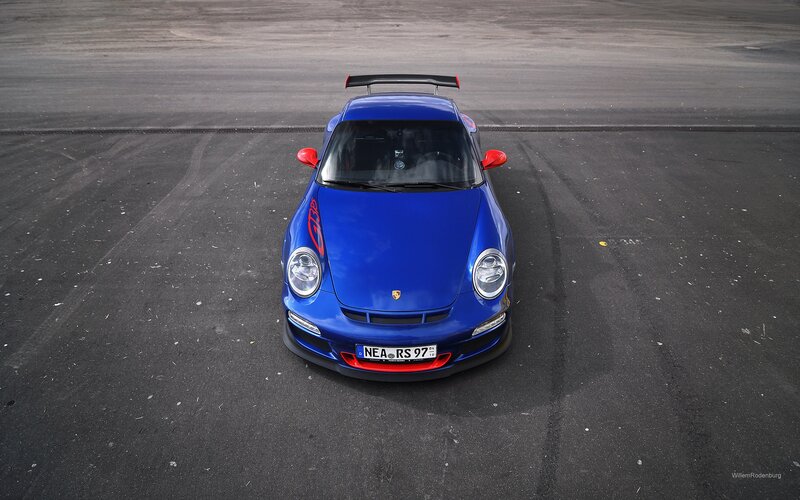 blue porsche on racetrack