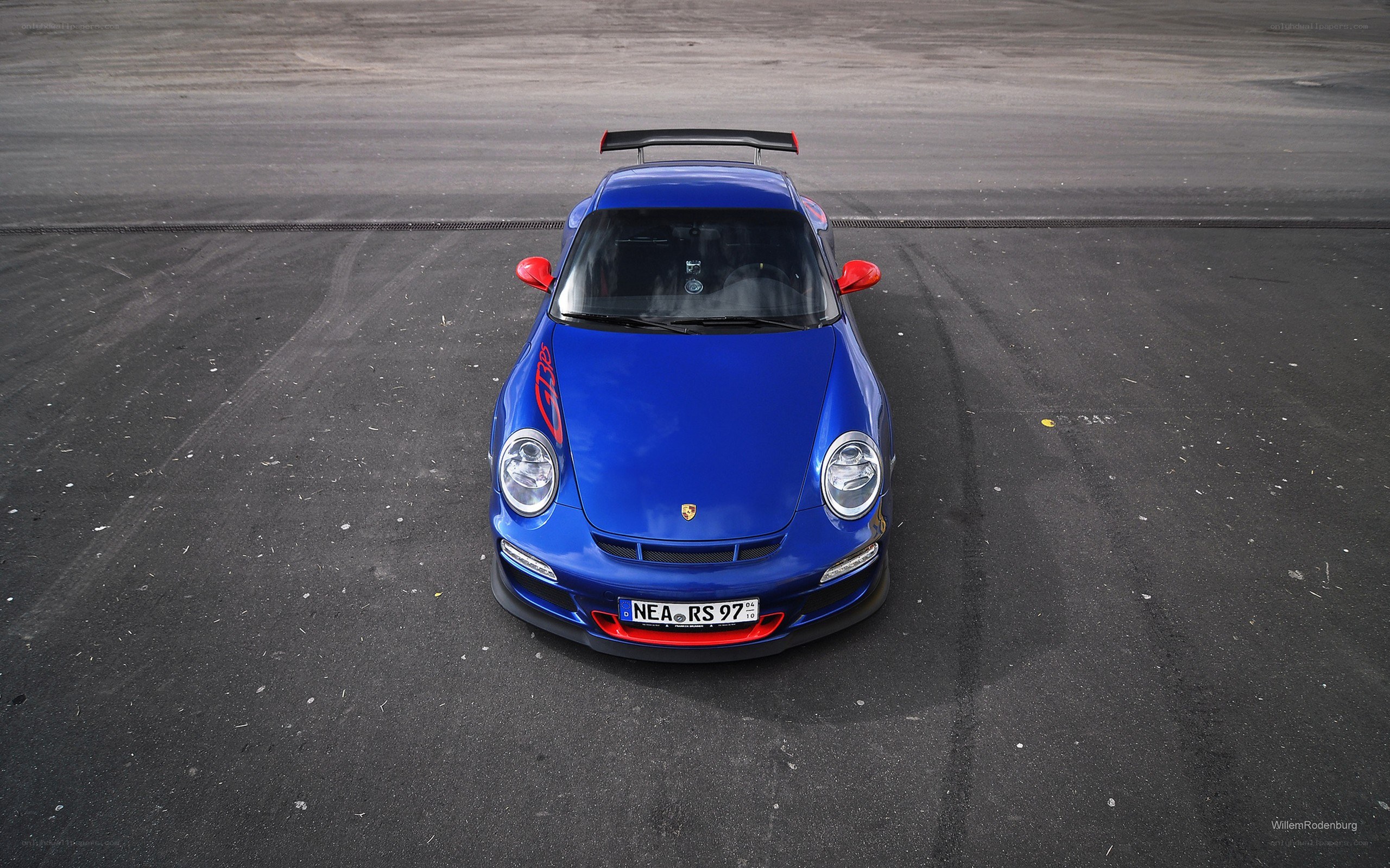blue porsche on racetrack