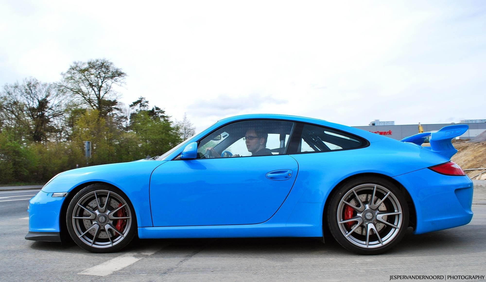 blue porsche on the road