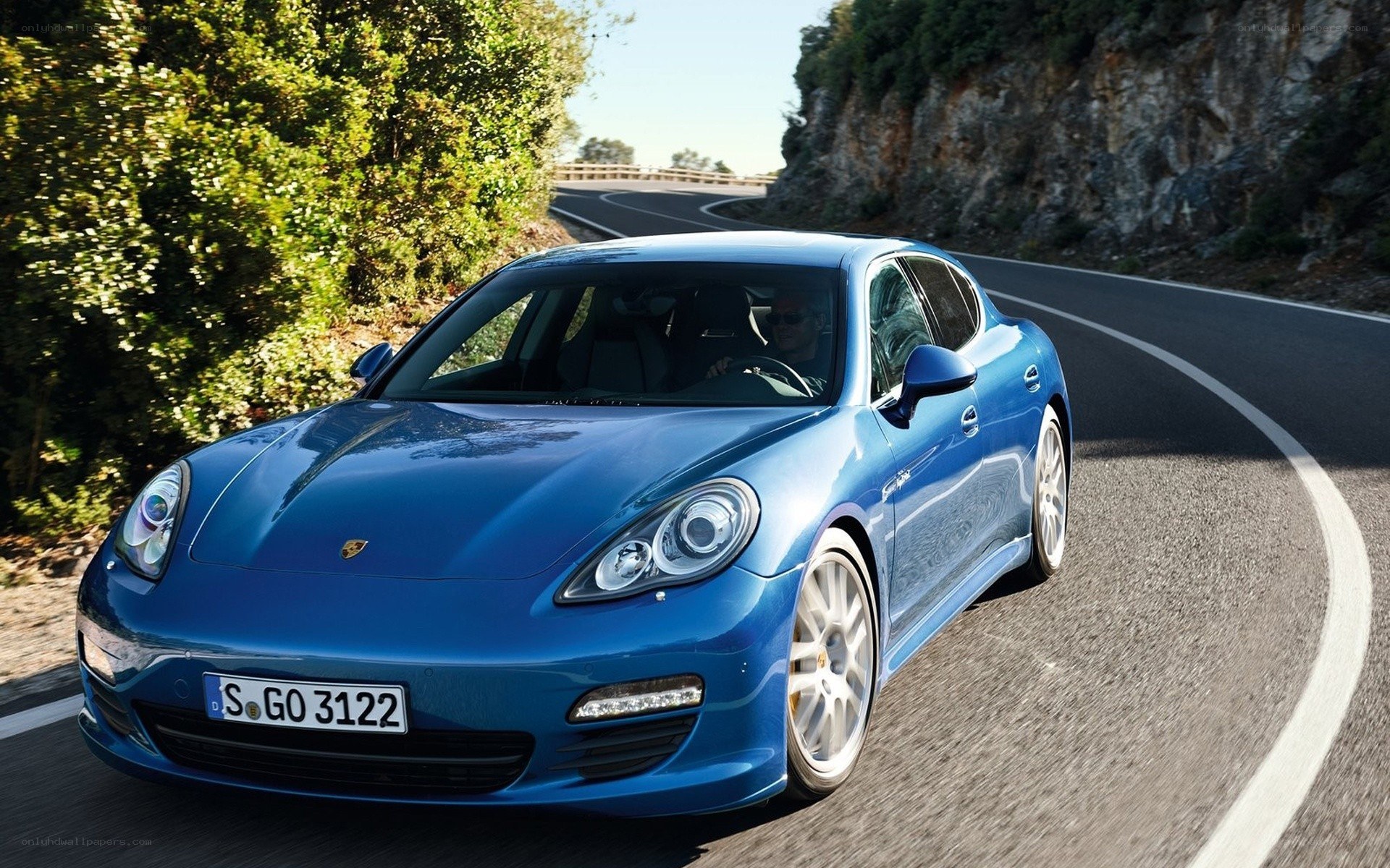 Blue Porsche on winding road