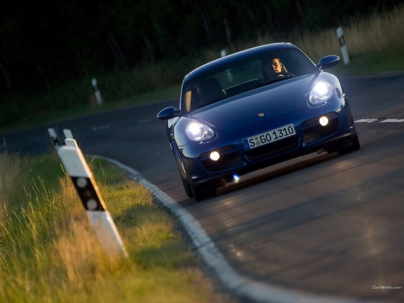 blue porsche on winding road