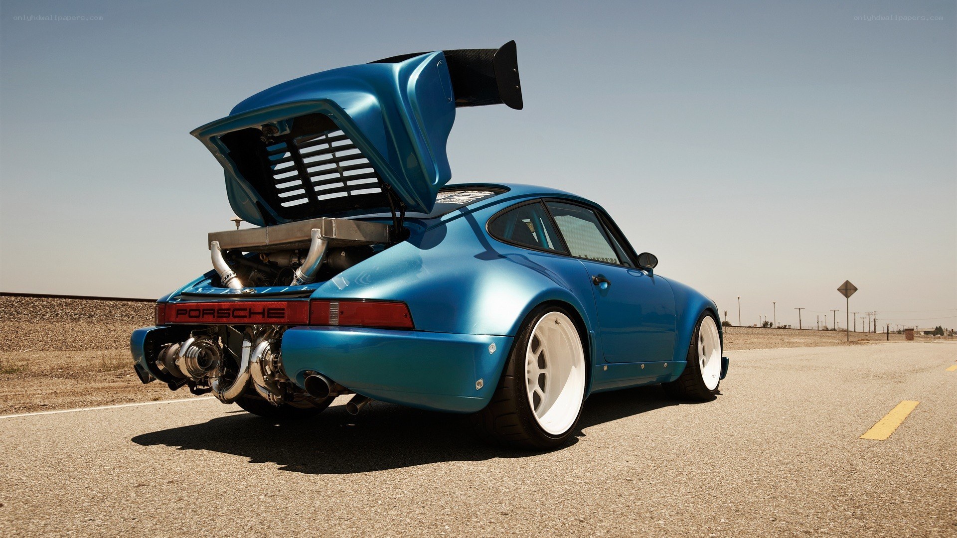 blue porsche with open engine bay