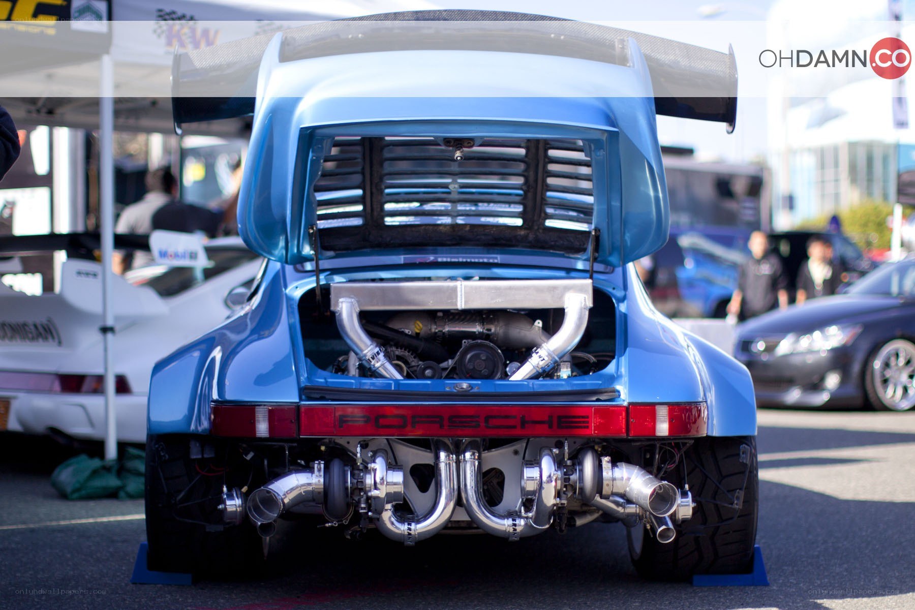 blue porsche with open engine bay