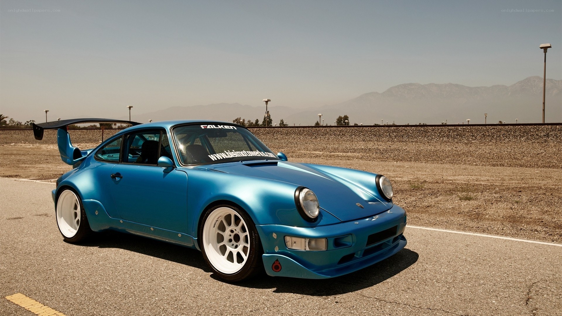 Blue Porsche with rear wing