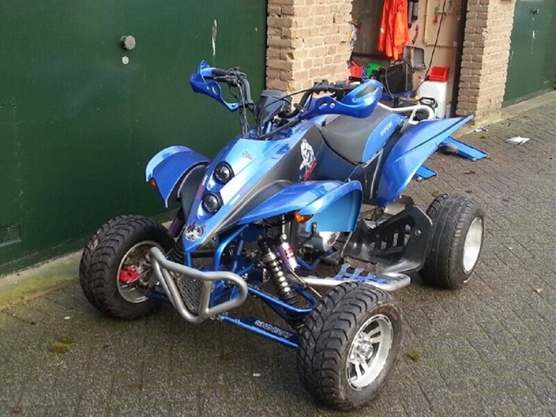 Blue Quad Bike — Neutral, Photograph, Green Wall
