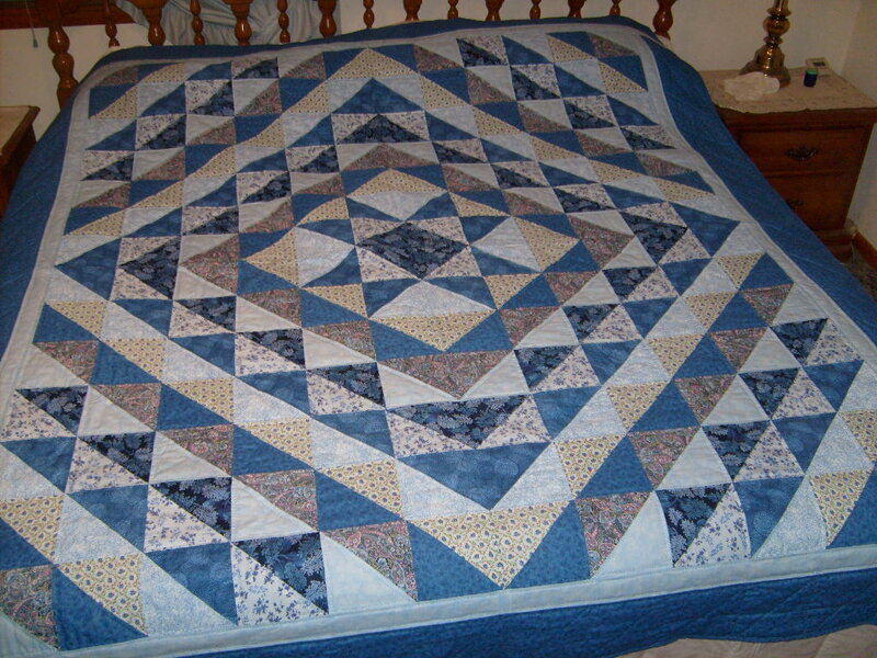 Blue quilt on a bed