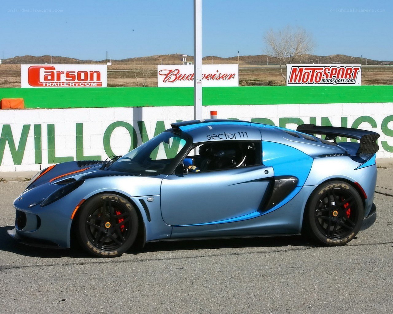 blue race car at track