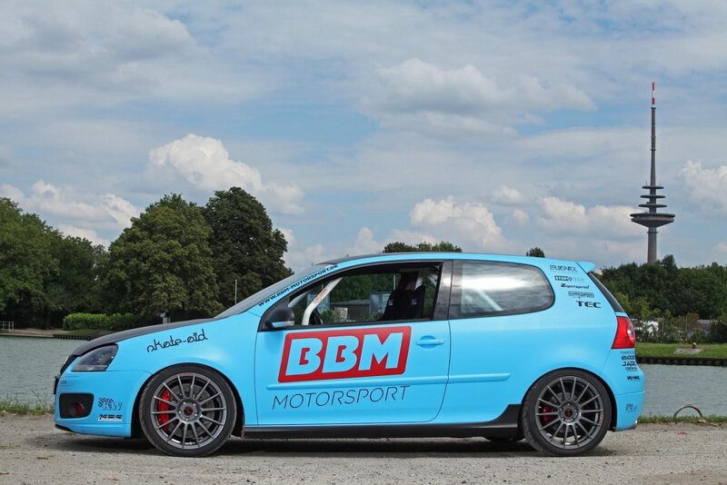 Blue race car by a lake