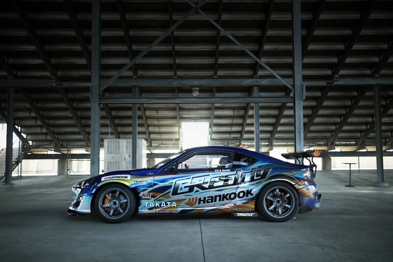 Blue Race Car — Dramatic, Photograph, Building