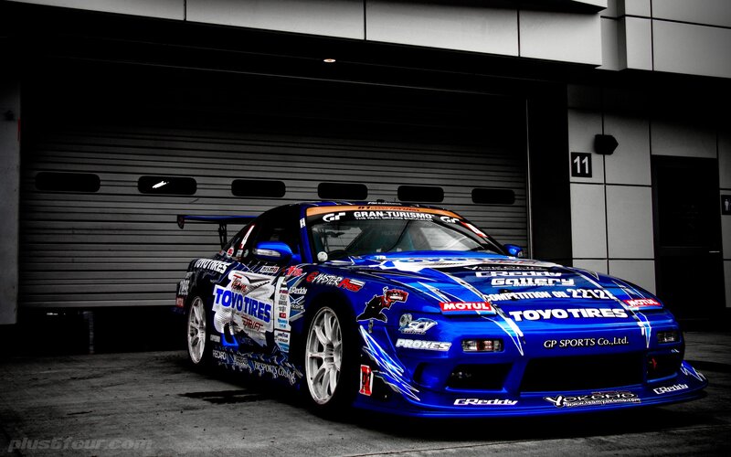 Blue Race Car — Dramatic, Photograph, Garage Door