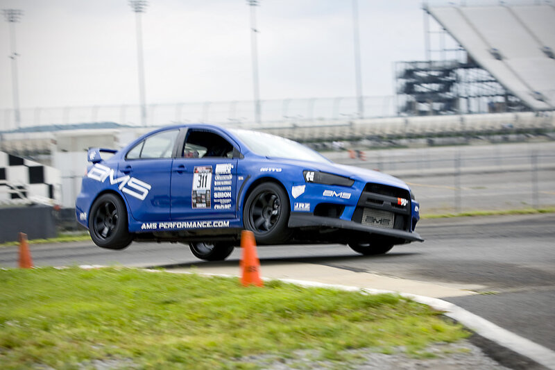 Blue Race Car — Dynamic, Afternoon, Photograph, Race Track, Orange Cone