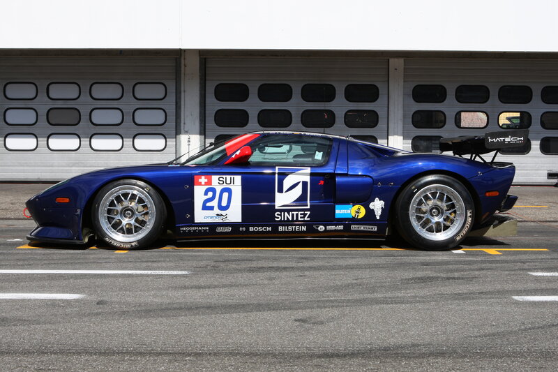 blue race car in pit lane