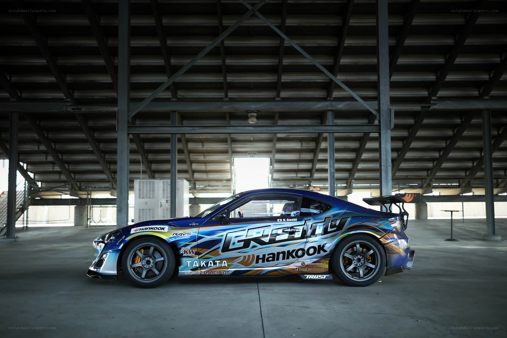 blue race car in warehouse