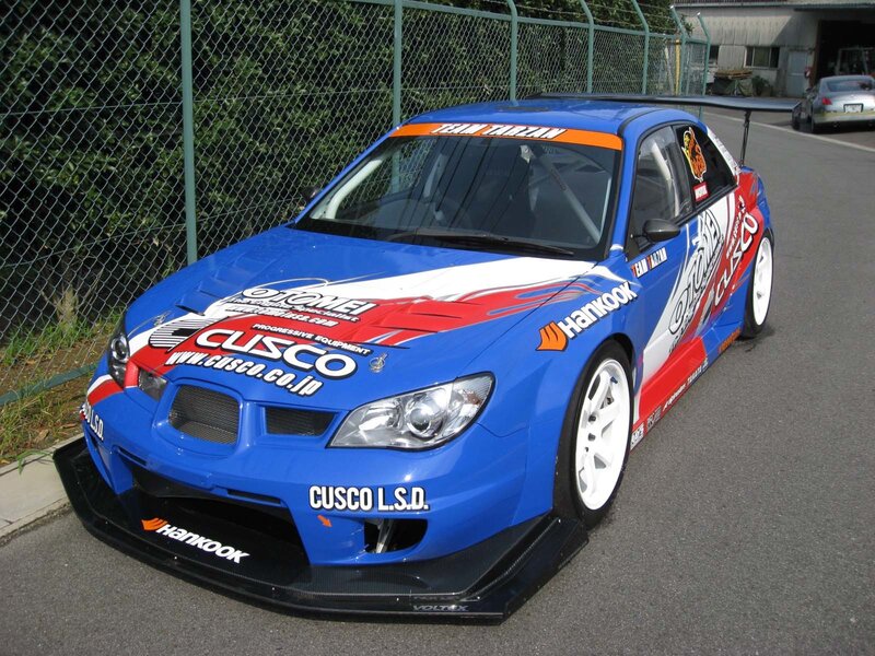 Blue Race Car — Neutral, Afternoon, Photograph, Fence, Road