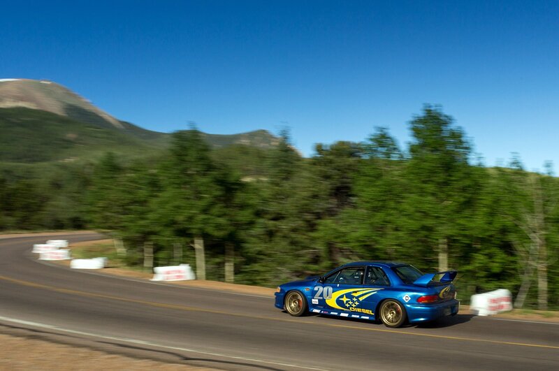 Blue race car on a mountain road