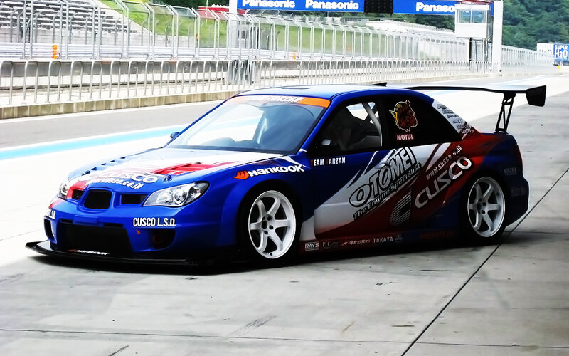 blue race car on track