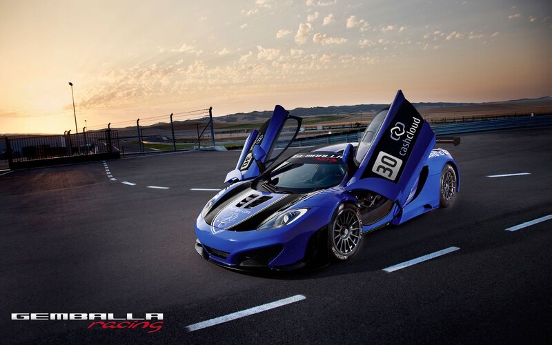 Blue race car on track at sunset