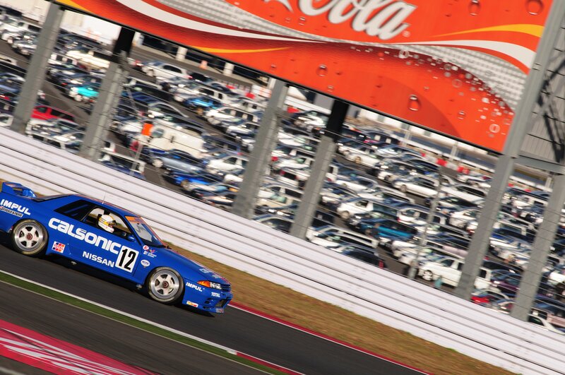 Blue Race Car on Track — Dynamic, Afternoon, Photograph, Coca-cola Sign