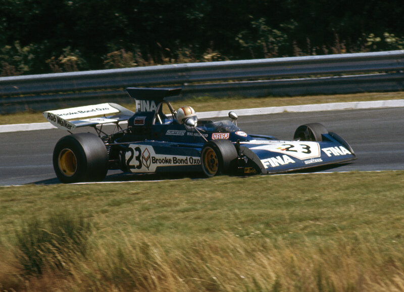 Blue Race Car on Track — Dynamic, Afternoon, Photograph, Driver, Race Car, Guardrail