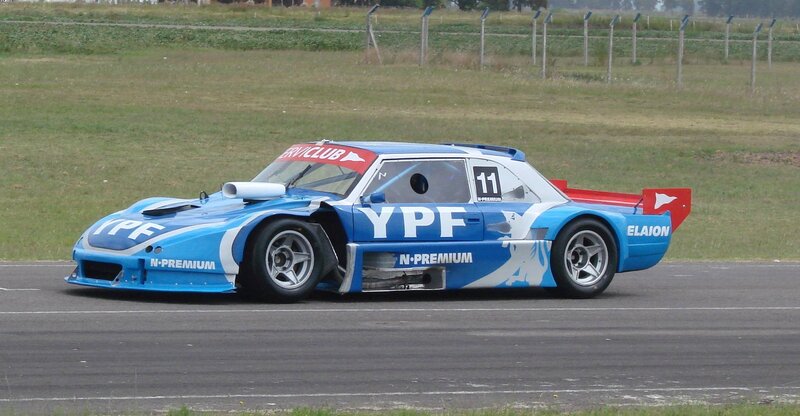 Blue Race Car on Track — Dynamic, Afternoon, Photograph, Race Car, Grass, White, Red