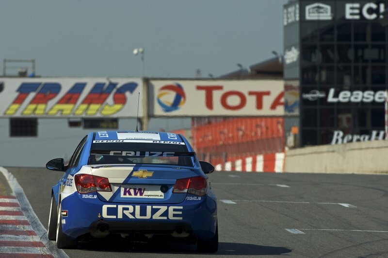 Blue Race Car on Track — Dynamic, Afternoon, Photograph, Race Track, Billboards