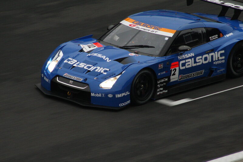 Blue Race Car on Track — Dynamic, Photograph, Race Car, Sponsor Logos, Black