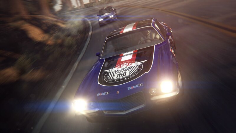 blue race car on winding road