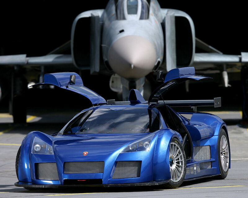 Blue race car with jet in background