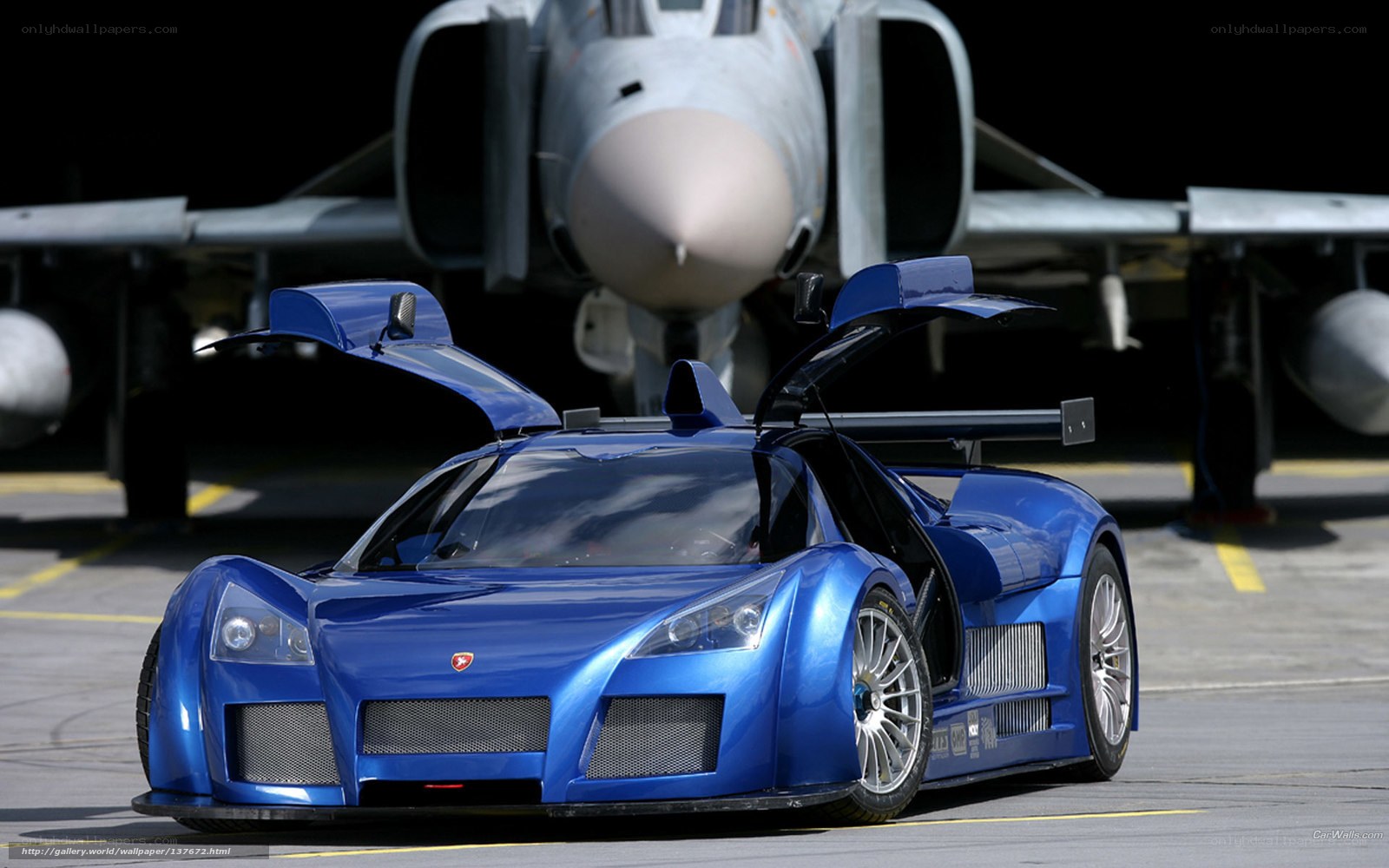 Blue race car with jet in background
