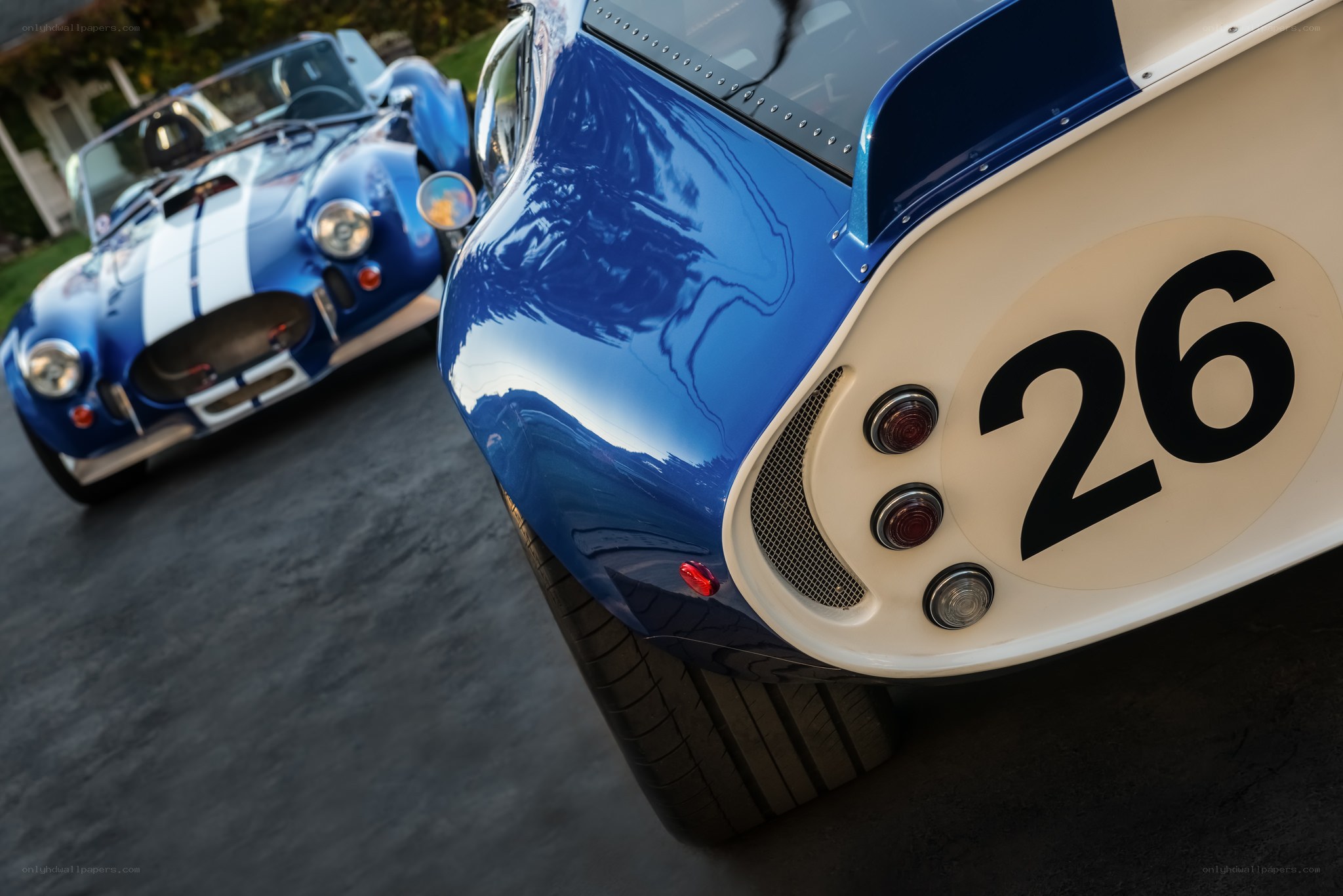 Blue racing cars on pavement