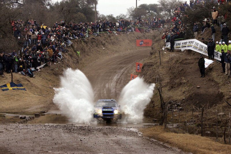 Blue Rally Car — Dynamic, Afternoon, Photograph, Crowd, Mud
