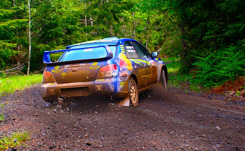 Blue Rally Car — Dynamic, Afternoon, Photograph, Dirt Road, Trees, Mud