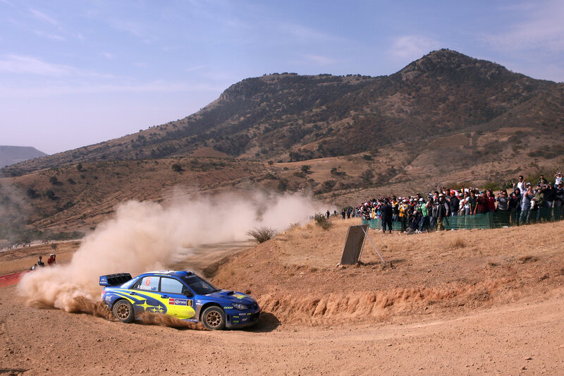 Blue Rally Car — Dynamic, Afternoon, Photograph, Dust Cloud, Spectators, Mountain