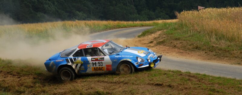 Blue Rally Car — Dynamic, Afternoon, Photograph, Dusty Road, Field, Trees