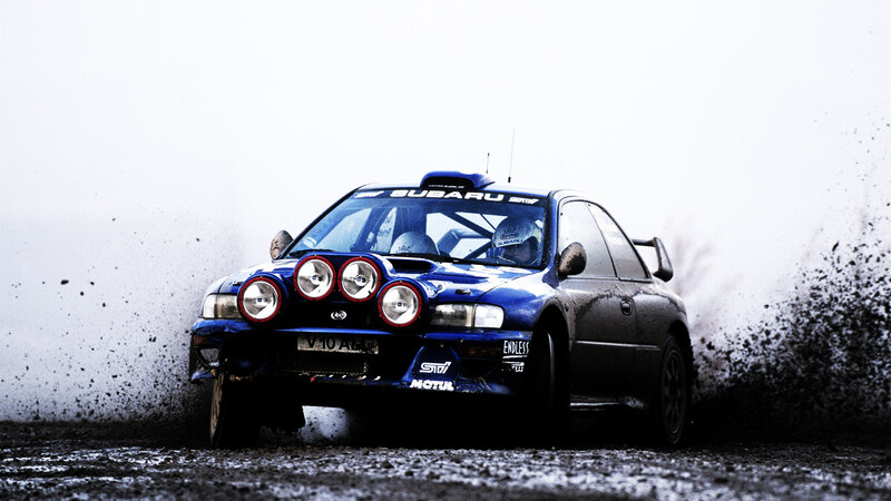Blue rally car in action