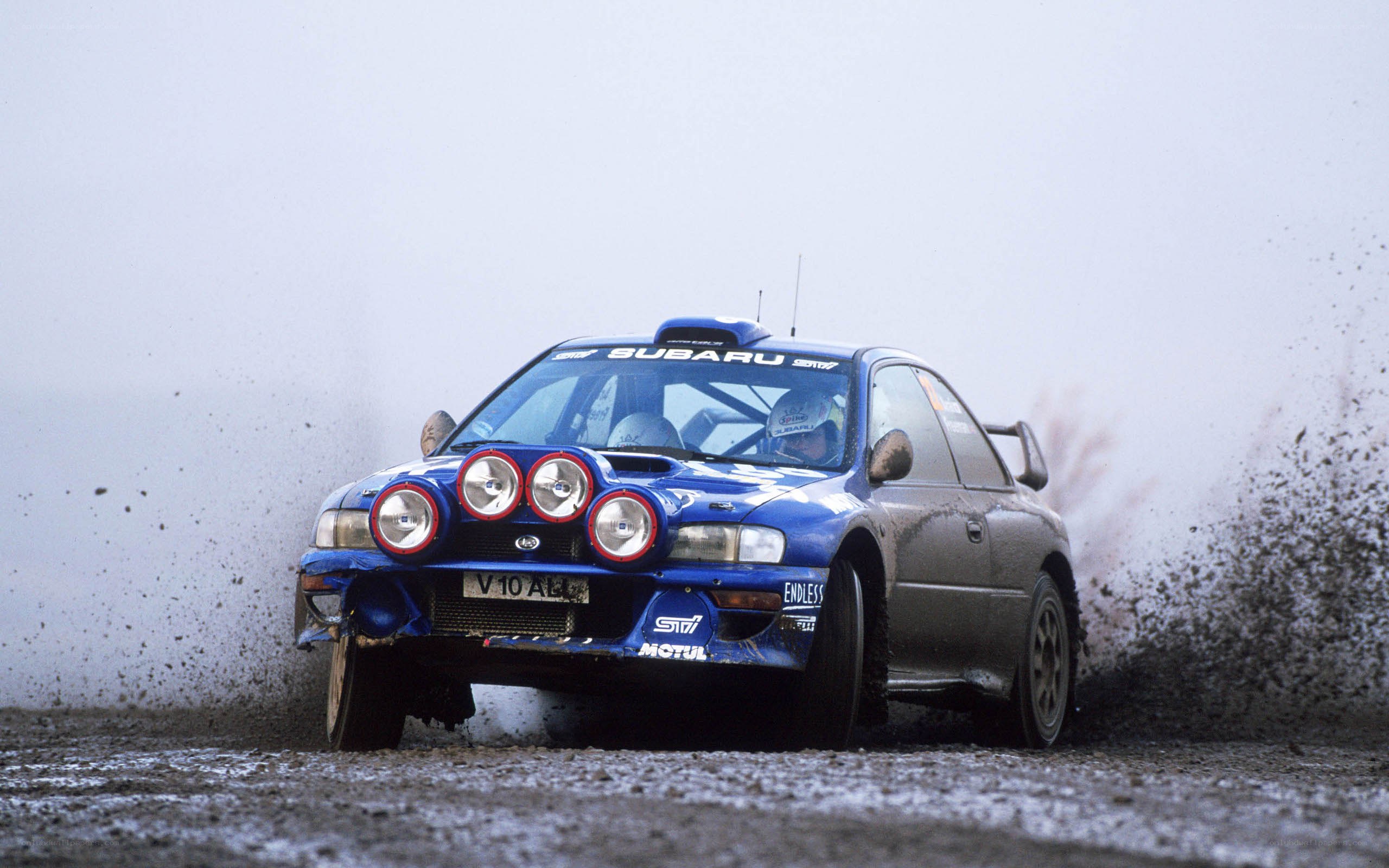 blue rally car in action
