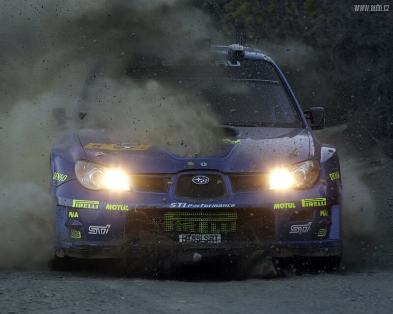 blue rally car in action