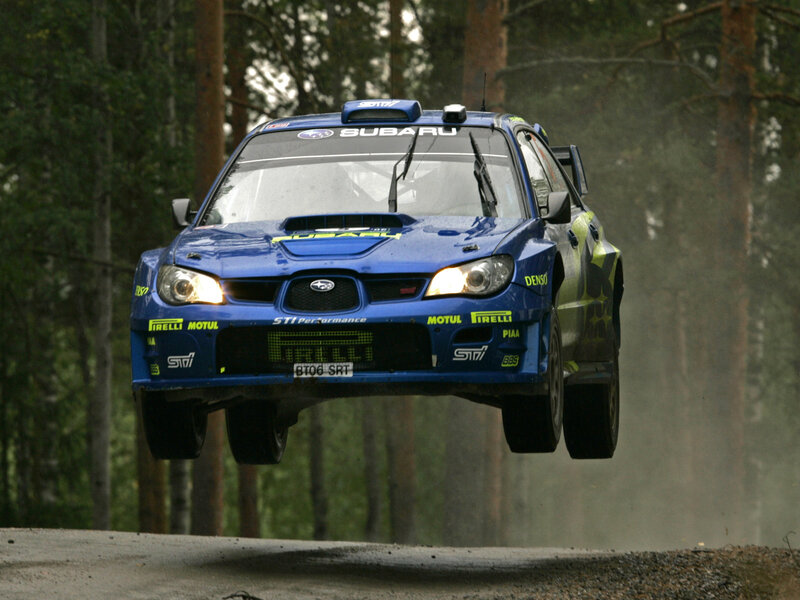 blue rally car in mid-air