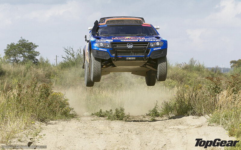 Blue Rally Car in Mid-air — Dynamic, Afternoon, Photograph, Dirt Track
