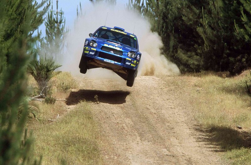 Blue Rally Car in Mid-air — Dynamic, Afternoon