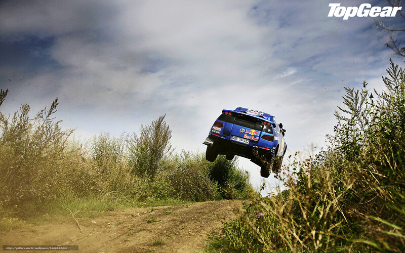 Blue rally car in mid-air jump