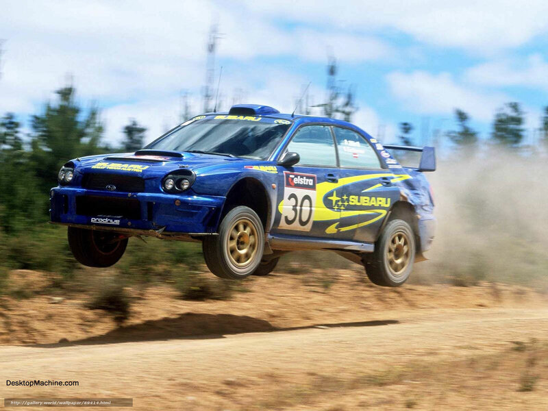 blue rally car in mid-air